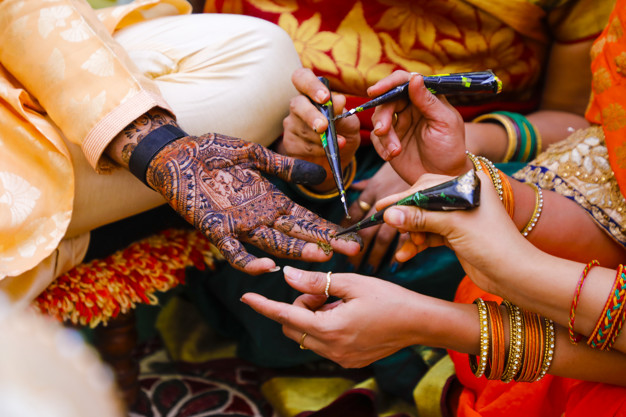 Indian wedding ceremony : groom hand with mehandi design